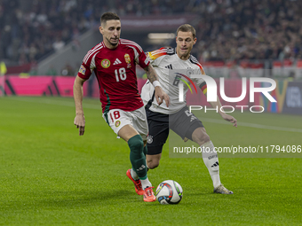 Zsolt Nagy of Hungary competes for the ball with Joshua Kimmich of Germany during the UEFA Nations League Group match at Puskas Arena in Bud...