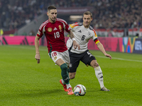 Zsolt Nagy of Hungary competes for the ball with Joshua Kimmich of Germany during the UEFA Nations League Group match at Puskas Arena in Bud...