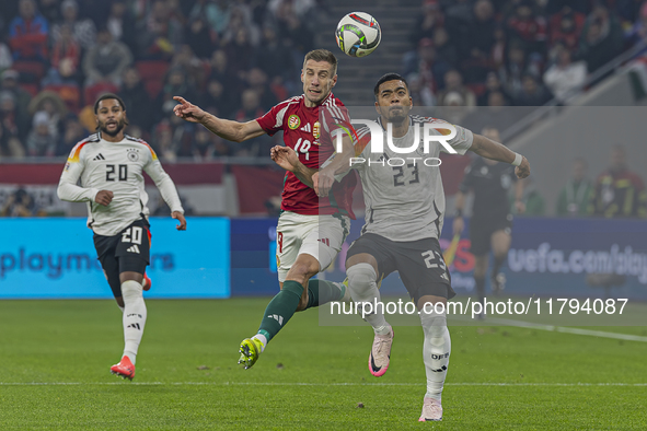 Barnabas Varga of Hungary competes for the ball with Benjamin Henrichs of Germany during the UEFA Nations League Group match at Puskas Arena...