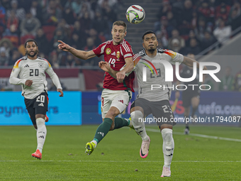 Barnabas Varga of Hungary competes for the ball with Benjamin Henrichs of Germany during the UEFA Nations League Group match at Puskas Arena...