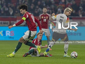 Andras Schafer of Hungary competes for the ball with Robert Andrich of Germany during the UEFA Nations League Group match at Puskas Arena in...