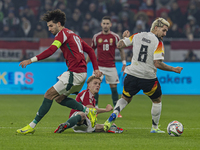 Andras Schafer of Hungary competes for the ball with Robert Andrich of Germany during the UEFA Nations League Group match at Puskas Arena in...