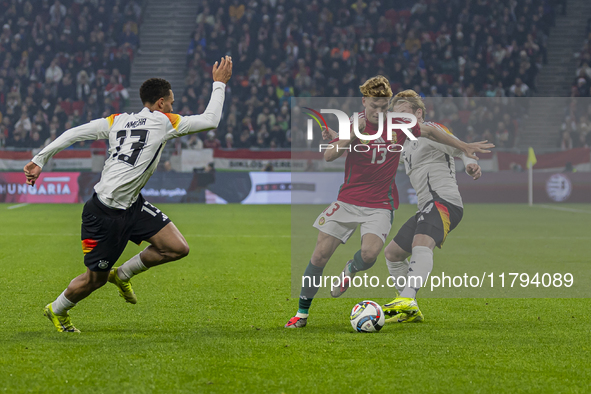 Andras Schafer of Hungary competes for the ball with Felix Nmecha of Germany during the UEFA Nations League Group match at Puskas Arena in B...