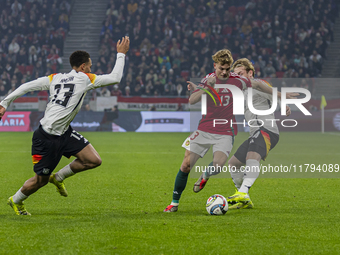 Andras Schafer of Hungary competes for the ball with Felix Nmecha of Germany during the UEFA Nations League Group match at Puskas Arena in B...