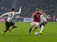 Andras Schafer of Hungary competes for the ball with Felix Nmecha of Germany during the UEFA Nations League Group match at Puskas Arena in B...