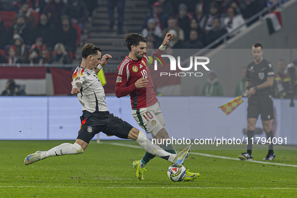 Robin Koch of Germany competes for the ball with Dominik Szoboszlai of Hungary during the UEFA Nations League Group match at Puskas Arena in...