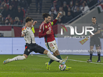 Robin Koch of Germany competes for the ball with Dominik Szoboszlai of Hungary during the UEFA Nations League Group match at Puskas Arena in...