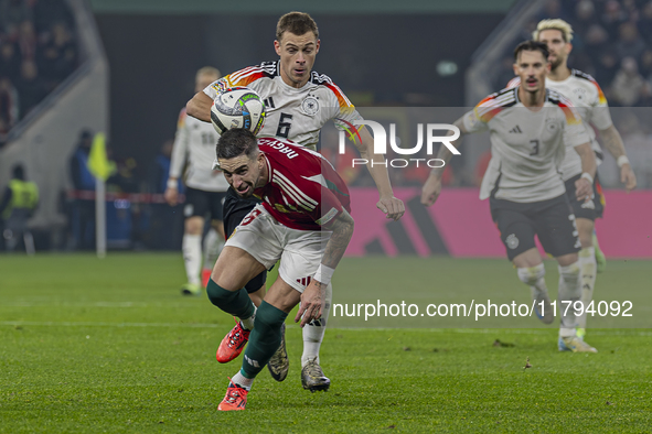 Zsolt Nagy of Hungary competes for the ball with Joshua Kimmich of Germany during the UEFA Nations League Group match at Puskas Arena in Bud...