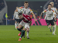 Zsolt Nagy of Hungary competes for the ball with Joshua Kimmich of Germany during the UEFA Nations League Group match at Puskas Arena in Bud...