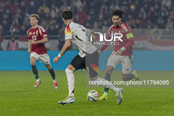 Dominik Szoboszlai of Hungary competes for the ball with Robin Koch of Germany during the UEFA Nations League Group match at Puskas Arena in...