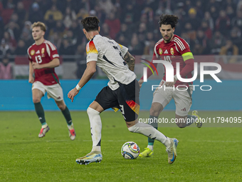 Dominik Szoboszlai of Hungary competes for the ball with Robin Koch of Germany during the UEFA Nations League Group match at Puskas Arena in...