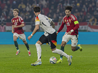 Dominik Szoboszlai of Hungary competes for the ball with Robin Koch of Germany during the UEFA Nations League Group match at Puskas Arena in...