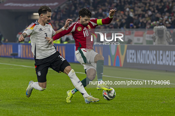 Dominik Szoboszlai of Hungary competes for the ball with Robin Koch of Germany during the UEFA Nations League Group match at Puskas Arena in...