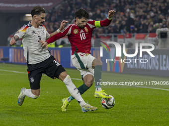 Dominik Szoboszlai of Hungary competes for the ball with Robin Koch of Germany during the UEFA Nations League Group match at Puskas Arena in...