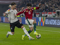 Dominik Szoboszlai of Hungary competes for the ball with Robin Koch of Germany during the UEFA Nations League Group match at Puskas Arena in...