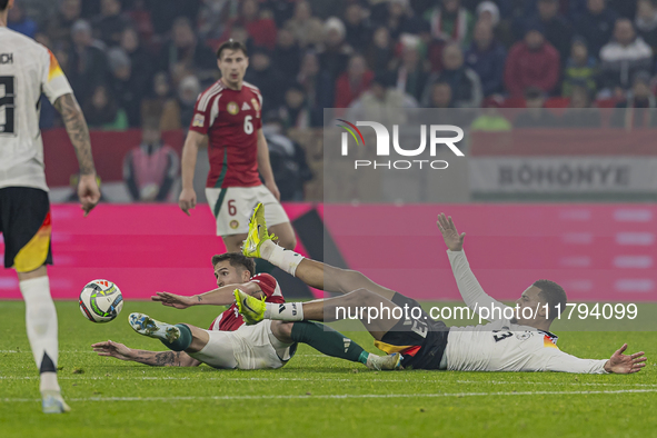 Felix Nmecha of Germany competes for the ball with Tamas Nikitscher of Hungary during the UEFA Nations League Group match at Puskas Arena in...