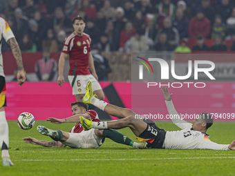 Felix Nmecha of Germany competes for the ball with Tamas Nikitscher of Hungary during the UEFA Nations League Group match at Puskas Arena in...