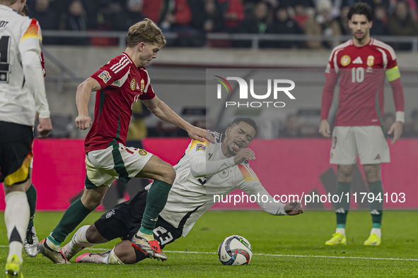 Andras Schafer of Hungary competes for the ball with Benjamin Henrichs of Germany during the UEFA Nations League Group match at Puskas Arena...