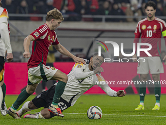 Andras Schafer of Hungary competes for the ball with Benjamin Henrichs of Germany during the UEFA Nations League Group match at Puskas Arena...