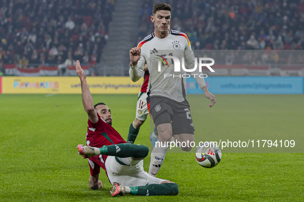 Robin Gosens of Germany competes for the ball with Attila Fiola of Hungary during the UEFA Nations League Group match at Puskas Arena in Bud...