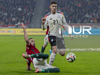 Robin Gosens of Germany competes for the ball with Attila Fiola of Hungary during the UEFA Nations League Group match at Puskas Arena in Bud...