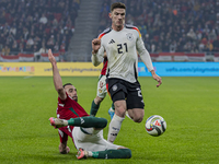 Robin Gosens of Germany competes for the ball with Attila Fiola of Hungary during the UEFA Nations League Group match at Puskas Arena in Bud...