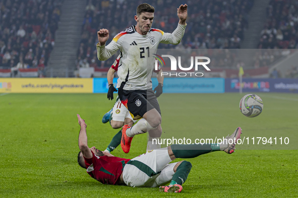 Robin Gosens of Germany competes for the ball with Attila Fiola of Hungary during the UEFA Nations League Group match at Puskas Arena in Bud...