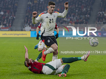 Robin Gosens of Germany competes for the ball with Attila Fiola of Hungary during the UEFA Nations League Group match at Puskas Arena in Bud...