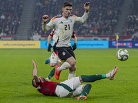 Robin Gosens of Germany competes for the ball with Attila Fiola of Hungary during the UEFA Nations League Group match at Puskas Arena in Bud...