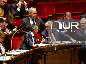 Bruno Retailleau, Minister for the Interior, speaks to Patrick Hetzel, Minister of Higher Education and Research, during the questions to th...