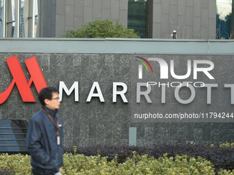 A citizen walks past a Marriott International hotel in Hangzhou, China, on November 20, 2024. (