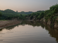 A view of a reservoir, locally called ''Jhiri,'' where water flows down from the mountain into the Jhiri. The mountains are not visible in t...