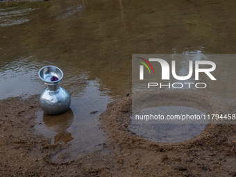 A water jar is near a reservoir locally called ''Jhiri'' in Durgapur, Netrokona, Bangladesh, on November 17, 2024. Locals create the circula...