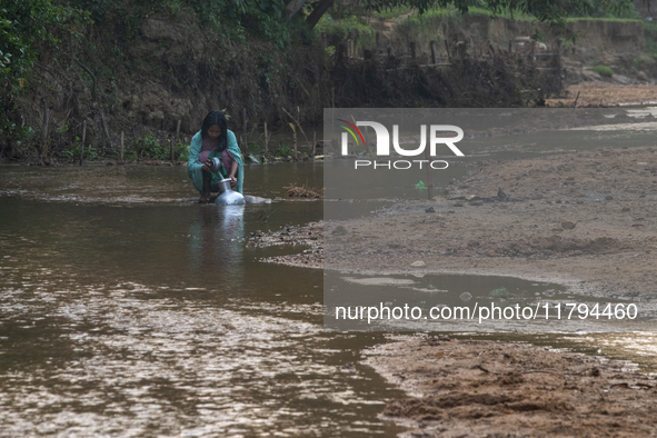 A local girl collects water from the reservoir locally called ''Jhiri'' in Durgapur, Netrokona, Bangladesh, on November 17, 2024. The reserv...