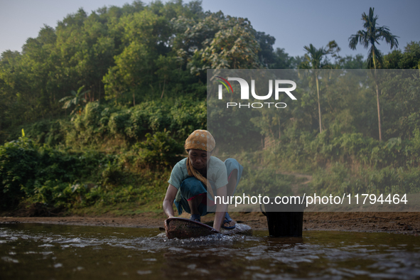 A tribal woman cleans vegetables at a reservoir, locally known as ''Jhiri,'' in Durgapur, Netrokona, Bangladesh, on November 17, 2024. The r...