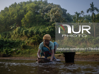 A tribal woman cleans vegetables at a reservoir, locally known as ''Jhiri,'' in Durgapur, Netrokona, Bangladesh, on November 17, 2024. The r...