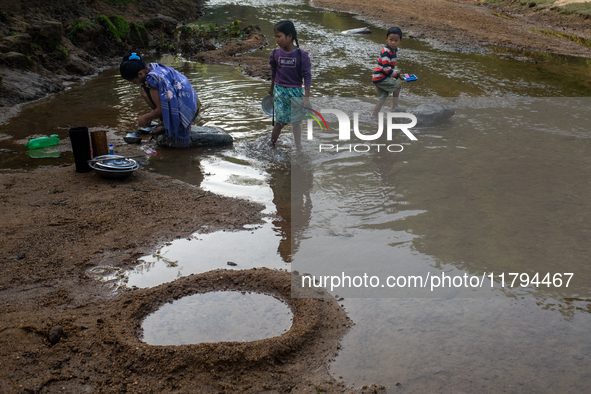 A family comes to the reservoir for their daily activities, such as cleaning dishes, brushing teeth, and bathing, in Durgapur, Netrokona, Ba...