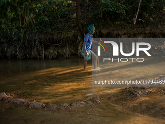 An old tribal man walks through the reservoir, locally called ''Jhiri,'' in Durgapur, Netrokona, Bangladesh, on November 17, 2024. The reser...