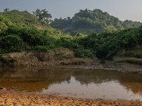 A view of a reservoir, locally called ''Jhiri,'' where water flows down from the mountain into the Jhiri. The mountains are not visible in t...