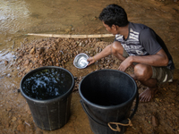 A tribal man collects water from the reservoir, locally known as ''Jhiri,'' in Durgapur, Netrokona, Bangladesh, on November 17, 2024. The re...