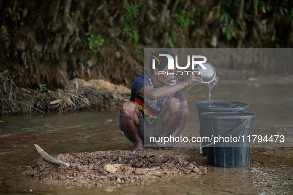 A tribal man collects water from the reservoir, locally known as ''Jhiri,'' in Durgapur, Netrokona, Bangladesh, on November 17, 2024. The re...