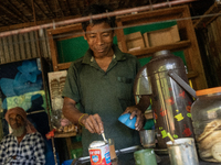 A tribal man makes tea at a local tea stall in Durgapur, Netrokona, Bangladesh, on November 17, 2024. Tea stalls serve as popular meeting po...