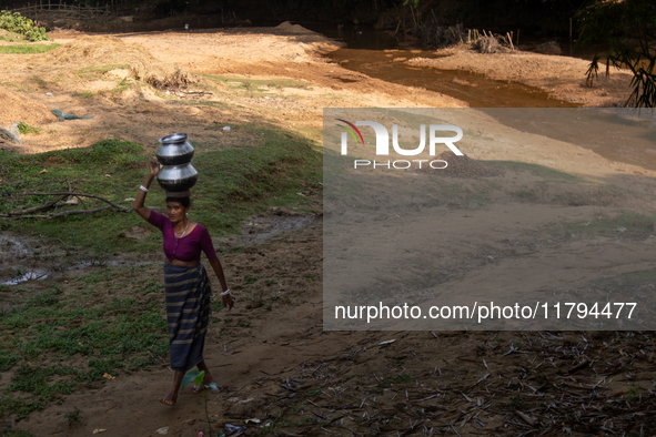 A tribal woman collects water from the reservoir, locally known as ''Jhiri,'' in Durgapur, Netrokona, Bangladesh, on November 17, 2024. The...