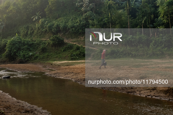 A tribal man collects water from the reservoir, locally known as ''Jhiri,'' in Durgapur, Netrokona, Bangladesh, on November 17, 2024. The re...