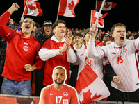 Fans celebrate Team Canada's goal during the CONCACAF Nations League Quarter Final Match between Team Canada and Suriname at BMO Field in To...