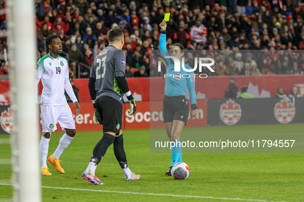 In Toronto, Ontario, Canada, on November 19, 2024, referee Katia Garcia shows a yellow card to Suriname goalkeeper E. Vaessen #23 during the...