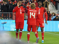 J. Shaffelburg #14 celebrates his second goal with C. Larin #9 and Ismael Kone #8 during the CONCACAF Nations League Quarter Final Match bet...