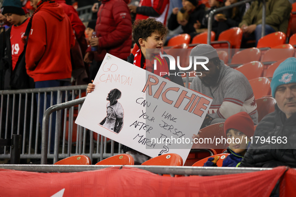 A young fan carries a message asking for Richie Laryea's jersey at the CONCACAF Nations League Quarter Final match between Team Canada and S...