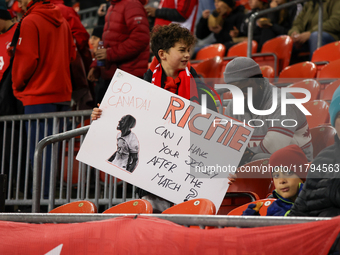 A young fan carries a message asking for Richie Laryea's jersey at the CONCACAF Nations League Quarter Final match between Team Canada and S...