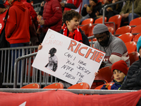 A young fan carries a message asking for Richie Laryea's jersey at the CONCACAF Nations League Quarter Final match between Team Canada and S...